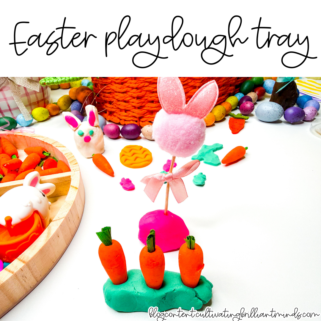 an easter playdough tray with mini carrots, pom poms, and easter grass