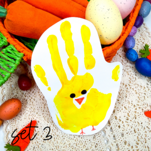 a handprint craft that is yellow with a chick face and feet drawn on
